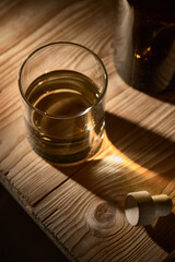 A glass of whiskey on a wooden table