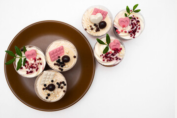 Trifles portioned mini cakes on plate. Layered trifle dessert with whipped cream and chocolate