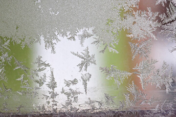 Beautiful winter background, frost on the window, natural texture on glass with a frozen pattern. Copy space, natural background, macro