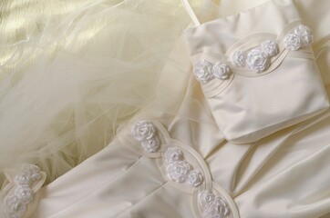 High Angle View Of Wedding Dress On Bed
