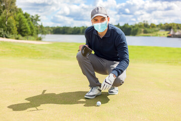 Golfer playing while wearing a mask, covid coronavirus outdoor sport concept