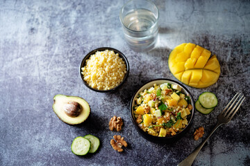 Millet mango avocado cucumber salad in a bowl