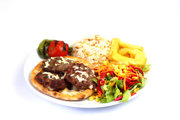 Plate of traditional grilled meatballs on white background