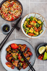 Asian food. Eggplant stir-fry, broken cucumbers, rice glass noodles with vegetables. Top view.