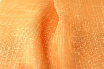Orange textile pattern texture, wrinkled linen cotton fabric background 