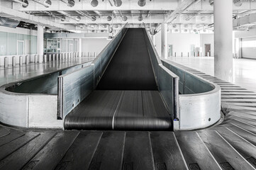 Airport terminal baggage carousel. Baggage conveyor belt in empty airport terminal. Old abandoned airport terminal.