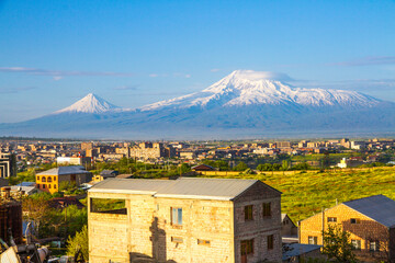 Fototapeta na wymiar Mount Ararat (Turkey) at 5,137 m viewed from Yerevan, Armenia. This snow-capped dormant compound volcano consists of two major volcanic cones described in the Bible as the resting place of Noah's Ark.