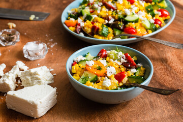 fresh summer salad of tomatoes, corn, cucumbers, and feta