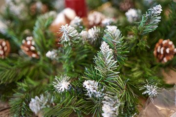 Naklejka na ściany i meble Happy new year blured background with artificial spruce branches and cones
