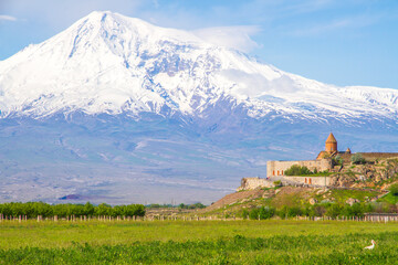 Fototapeta na wymiar Khor Virap monastery in front of Mount Ararat viewed from Yerevan, Armenia. This snow-capped dormant compound volcano described in the Bible as the resting place of Noah's Ark.