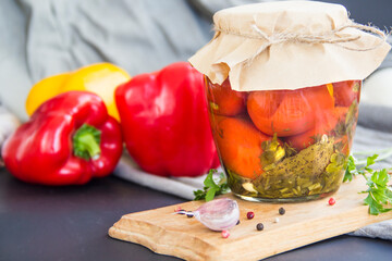 Jars of tasty pickled vegetables on a table. Creative atmospheric decoration