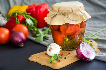 Jars of tasty pickled vegetables on a table. Creative atmospheric decoration