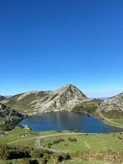 Naklejka na ściany i meble The Lakes of Covadonga. The Lake Enol is a small highland lake in the Principality of Asturias, Spain. It is located in the Picos de Europa Western Massif, Cantabrian Mountains.