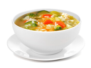 Healthy vegetable soup with rice in a white bowl with saucer. Side view isolated on a white background.