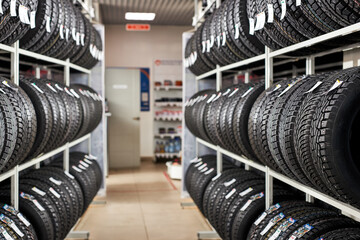 assortment of tires for car in repair garage, replacement of winter and summer tires. seasonal tire replacement concept.