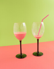 Cold and fresh pink drink for summer party on green, pink and green background