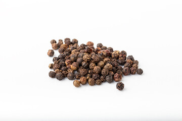 Heap of black pepper corn isolated on white background.