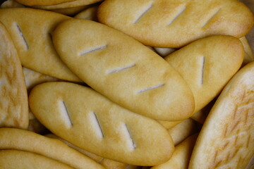 Close-up of small cookies, top view, macro, loaf-shaped