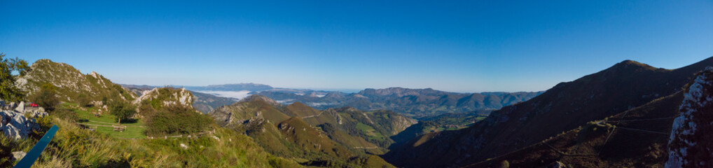 Fototapeta na wymiar Panoramic view from Reina Lookout (Mirador de la Reina) over the mountain tops of Picos de Europa National Park, Asturias, Spain. This viewpoint is on the Los Lagos road.