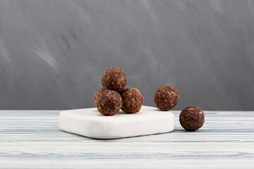 Raw vegan sweets, energy balls with dates, nuts, dried fruits, and carob powder. Vegetarian round...