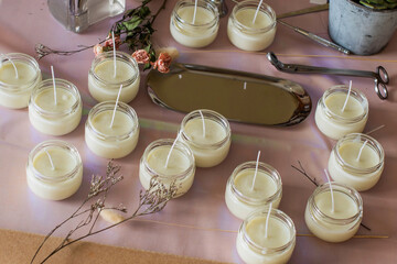 Many soy wax candles together on store or workshop background. pottery store. Ecological and vegan business. Soya wax candle accessories. Handmade with love. Remote work, online shop, workplace