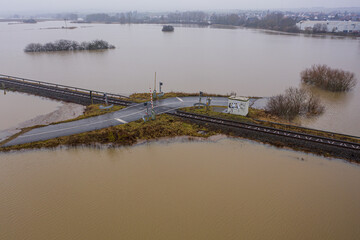 Flooded road passing through the railway. A road under water