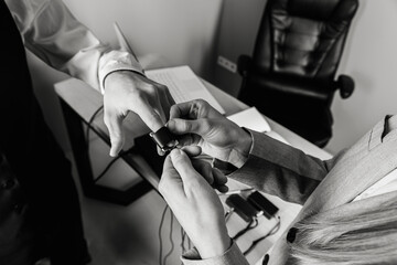 close-up, girl puts on a man's hand sensors for passing a polygraph, a truth detector. The concept of passing a polygraph