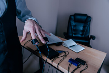 close-up, girl puts on a man's hand sensors for passing a polygraph, a truth detector. The concept of passing a polygraph