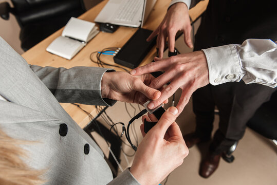 close-up, girl puts on a man's hand sensors for passing a polygraph, a truth detector. The concept of passing a polygraph