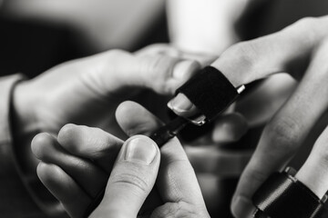 close-up, girl puts on a man's hand sensors for passing a polygraph, a truth detector. The concept of passing a polygraph