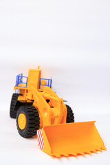 Obraz na płótnie Canvas Scale model of a yellow single-bucket loader on white background