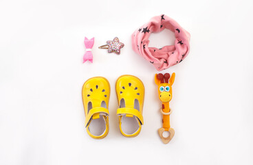 children's clothing and shoes on a white background top view. Space for the text.