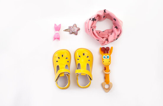 children's clothing and shoes on a white background top view. Space for the text.