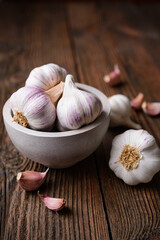 Natural antibiotic, fresh garlic bulbs with cloves on wooden background