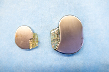  pacemaker and an implantable defibrillator lying on a light blue base - obrazy, fototapety, plakaty