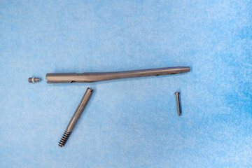 one explanted femoral nail lies on a light blue support
