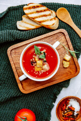 Fresh Cold tomato soup with bread on table. Summer Spanish food. Top view, copy space