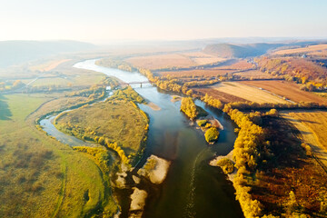 Aerial top view of winding river in sunny day.