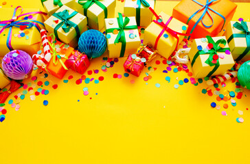 colorful gift boxes on a yellow background top view. Space for the text.