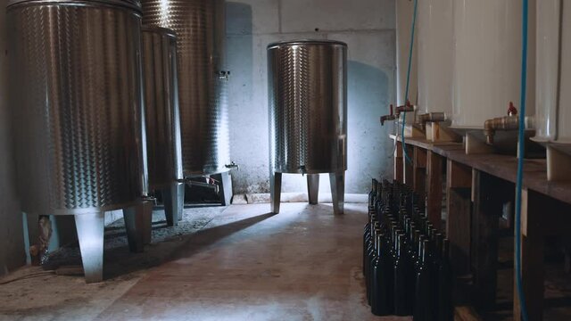 Interior of modern wine factory sollar. Stainless steel metallic alcohol distillery machines for storing and fermenting wine.