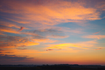 Fototapeta na wymiar Spectacular colorful sunset with cloudy sky. Photo of textured sky.