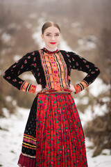 Young beautiful slovak woman in traditional dress. Slovak folklore