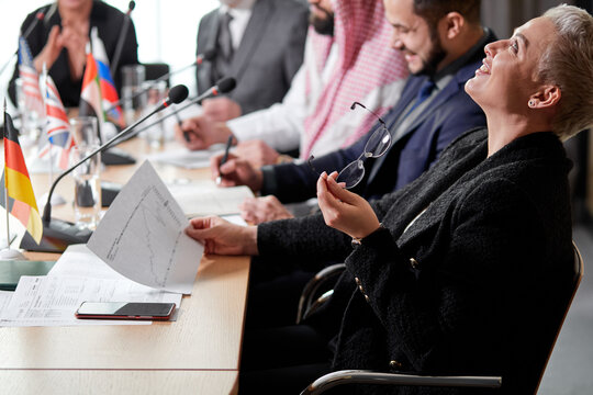 Short Haired Executive Woman Is In Shock After What She Saw In The Document, She Threw Her Head Back And Laugh, During Meeting In Boardroom