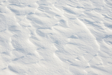 Fresh clean white snow background texture. Winter background with frozen snowflakes and snow mounds. Snow lumps. Seasonal landscape details. Cold weather.