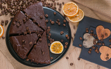 slices of chocolate brownie cake with glass of milk and coffee beanas on wooden table