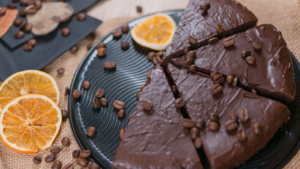slices of chocolate brownie cake with glass of milk and coffee beanas on wooden table