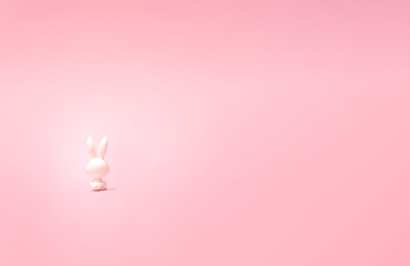 A lonely toy rabbit sitting and staring in pastel pink distance. Photo of its back.