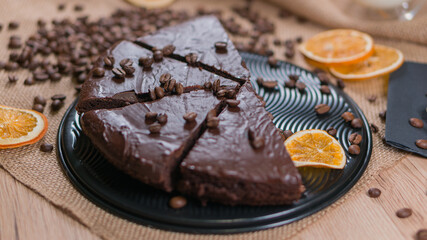 slices of chocolate brownie cake with glass of milk and coffee beanas on wooden table