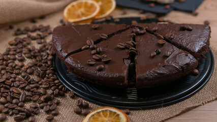 slices of chocolate brownie cake with glass of milk and coffee beanas on wooden table
