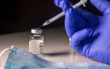 Medication Vial and Syringe for Corona-19 Vaccination in a Clinical, Isolated background.